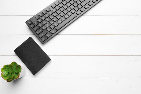 Business work place with equipment on wooden desk, top view