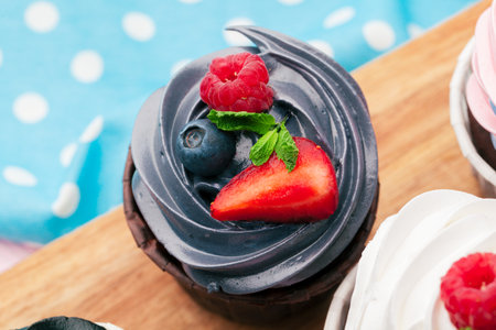 Cupcakes decorated with sprinkles and frosting - close upの写真素材