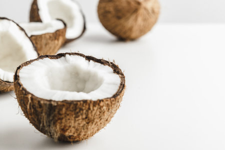 Ripe coconut pieces on white background, copy space