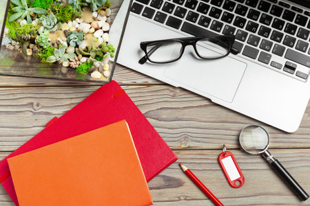 Office tools on gray wooden background top view close upの写真素材
