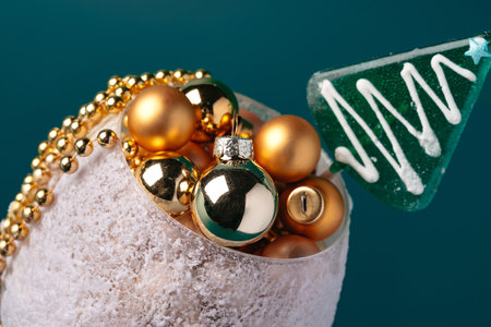 Little christmas baubles in wineglasses on a dark backgroundの写真素材