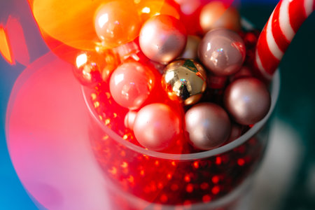 Little christmas baubles in wineglasses on a dark backgroundの写真素材