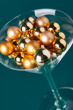 Glass with Christmas decorations on dark green backgroundの写真素材