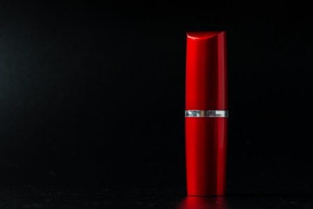 Red lipstick on dark paper background close upの写真素材