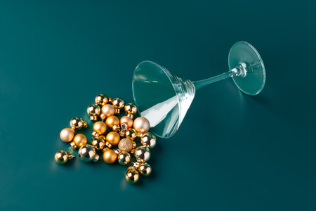 Glass with Christmas decorations on dark green backgroundの写真素材