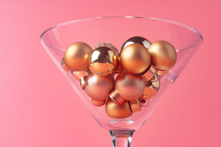 Glass with Christmas decorations on pink pastel backgroundの写真素材