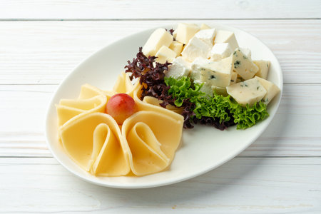 Assortment of cheese on a white plateの写真素材