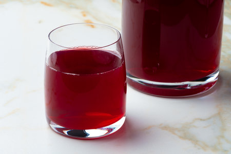 Pitcher and glass of compote on table