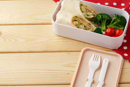 Lunch boxes with ready food on wooden backgroundの写真素材