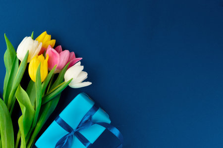 Fresh flowers and gift box with ribbonの写真素材