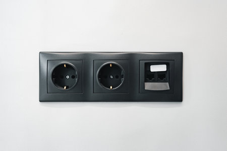 Black electrical outlet socket on a room wallの写真素材