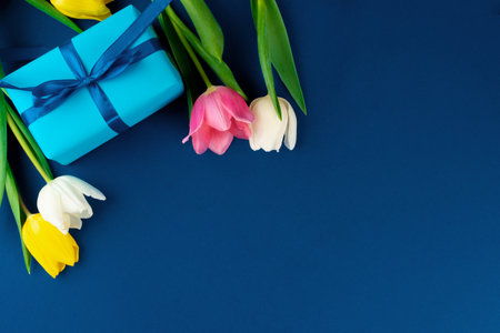 Fresh flowers and gift box with ribbonの写真素材