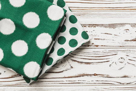 Green polka dot napkin on weathered wooden background