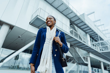 Attractive young african woman walking in the city