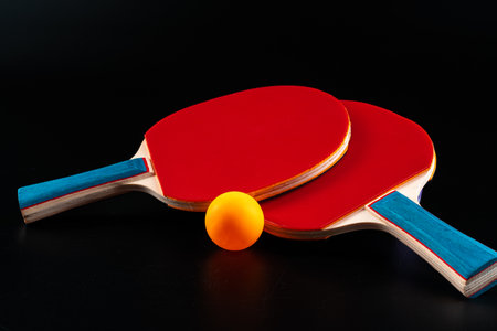 Red table tennis racket on dark backgroundの写真素材