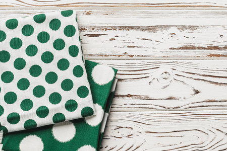 Green polka dot napkin on weathered wooden backgroundの写真素材