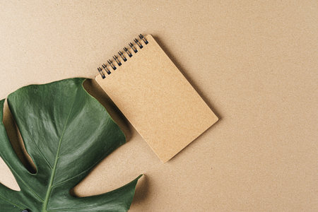 Flat lay craft paper card mockup with leaves