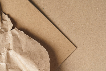 Crumpled craft paper with carton sheets close upの写真素材