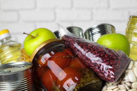 Set of raw cereals, grains, pasta and canned food on the table.の写真素材