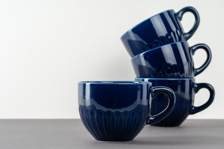 Dark blue ceramic coffee cup on tableの写真素材