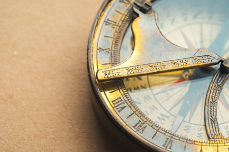 Vintage metal compass on carton paper close up