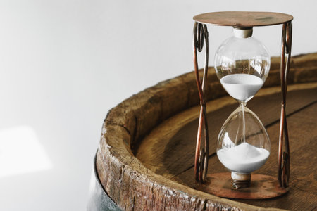 Sandglass on wooden bakground closeup. Time conceptの写真素材