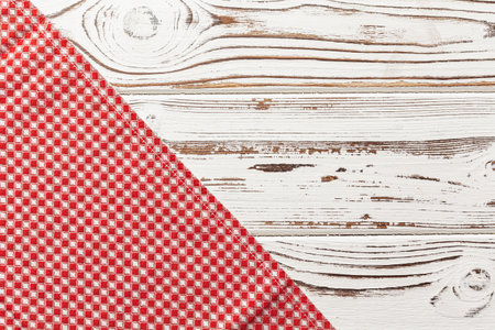 Red checkered napkin or tablecloth on wooden table