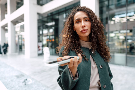 Young woman reading a message or using the phone in the cityの写真素材