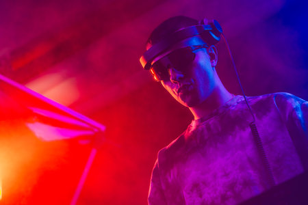 Club DJ playing music at party wearing sunglassesの写真素材