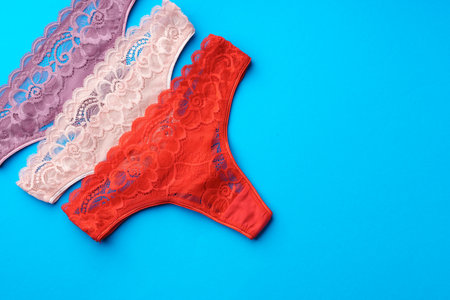Womens panties on a blue background in studio