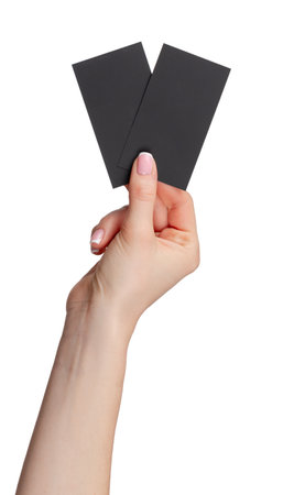 Female hand holding black businesscard isolated on white backgroundの写真素材