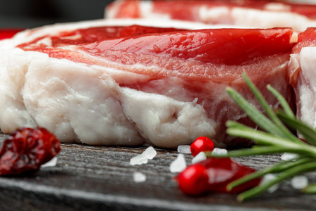 fresh meat with ingredients for cooking on dark backgroundの写真素材