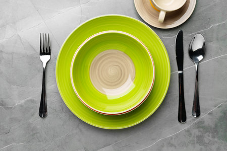 Color ceramic plates on gray background top viewの写真素材