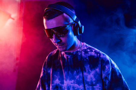 Club DJ playing music at party wearing sunglassesの写真素材