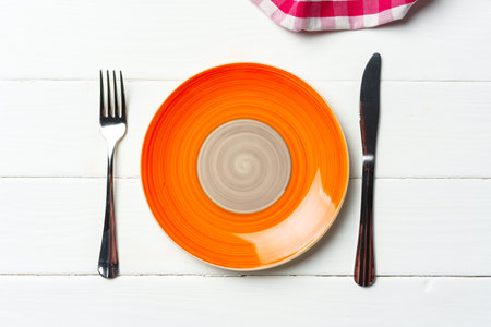 Top view of color ceramic plate on wooden backgroundの写真素材