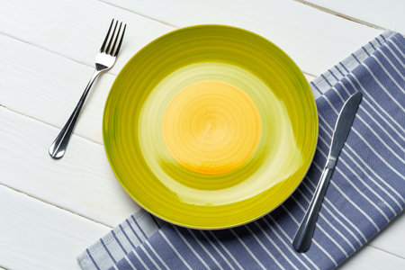 Top view of color ceramic plate on wooden backgroundの写真素材