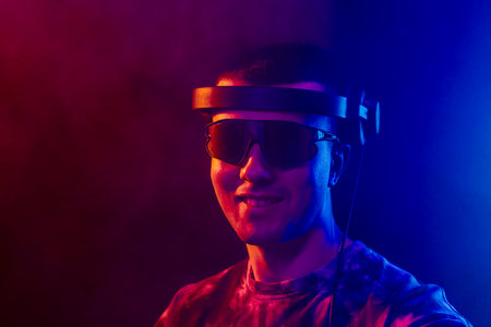 Club DJ playing music at party wearing sunglasses