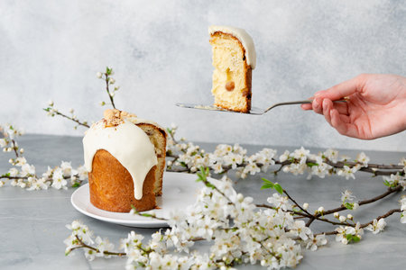 Hand holding piece of Easter cake on dessert spatula