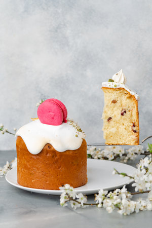 Piece of Easter cake on plate decorated with spring flower branchesの写真素材