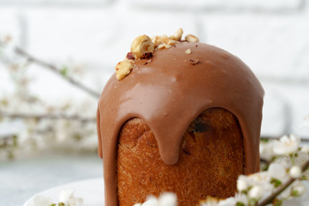 Ester cake with chocolate topping and nuts on gray background