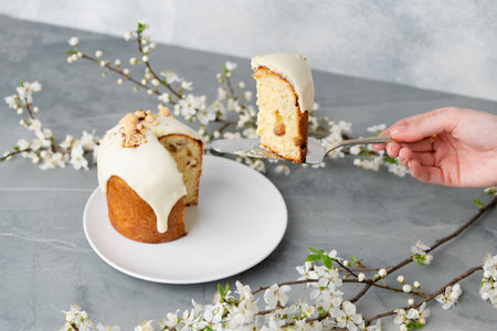 Hand holding piece of Easter cake on dessert spatula