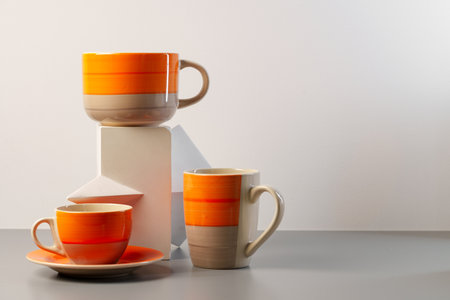 Colorful clay ceramic cups on gray backgroundの写真素材