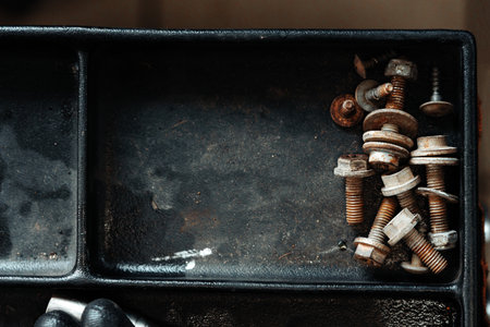 Old box with rusty bolts close up