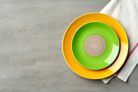 Top view of ceramic plate with table napkin on gray backgroundの写真素材