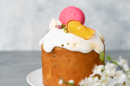 Beautiful Easter cake decorated with macarons cookie and dry orange piece