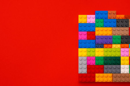 Plastic constructor details on red background close upの写真素材