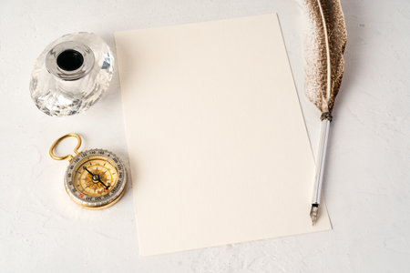Old paper with compass and quill pen top viewの写真素材