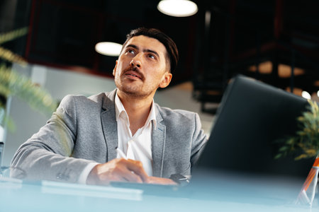 Young arab businessman working at the table in modern office