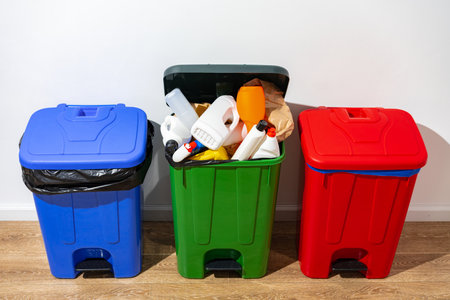 Trash cans full of waste in the buildingの写真素材
