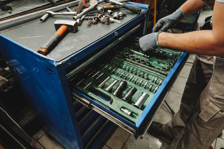 Male technician standing near tool table in car serviceの写真素材